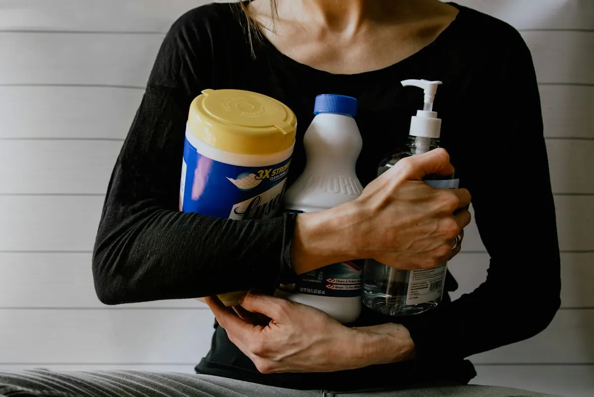Person holding bottles of household cleaning products