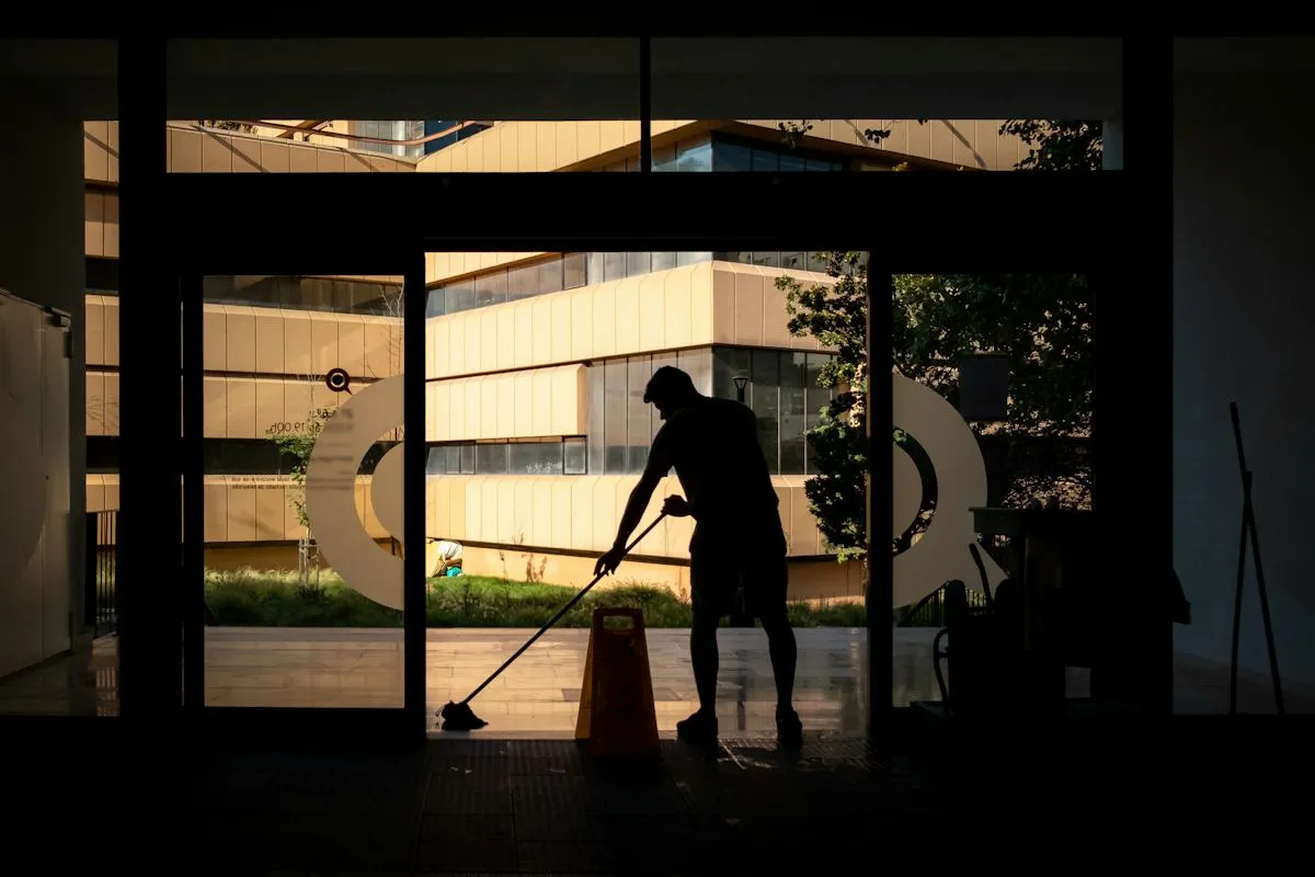 Worker cleaning the windows of an office building