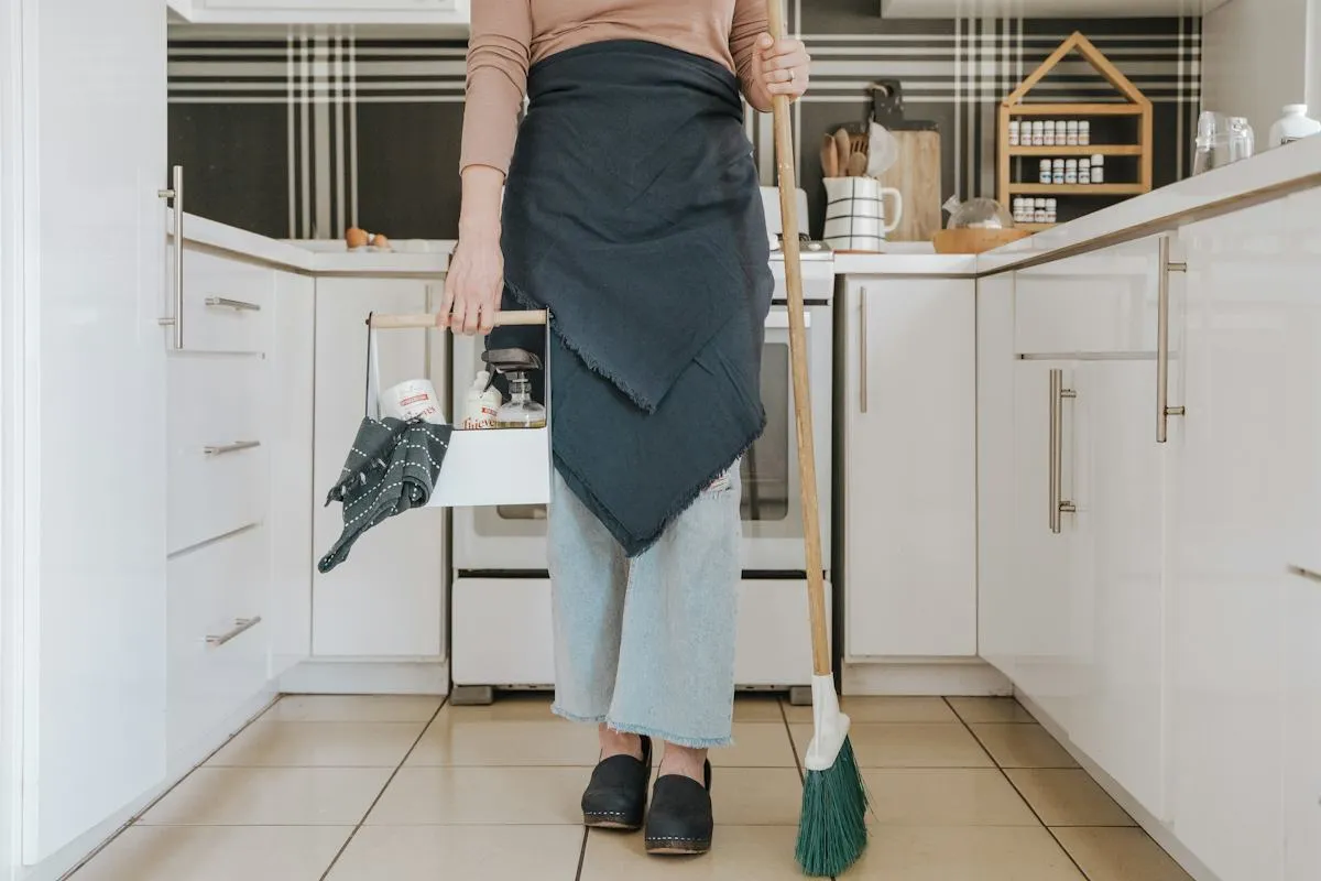 Staff member cleaning a kitchen floor