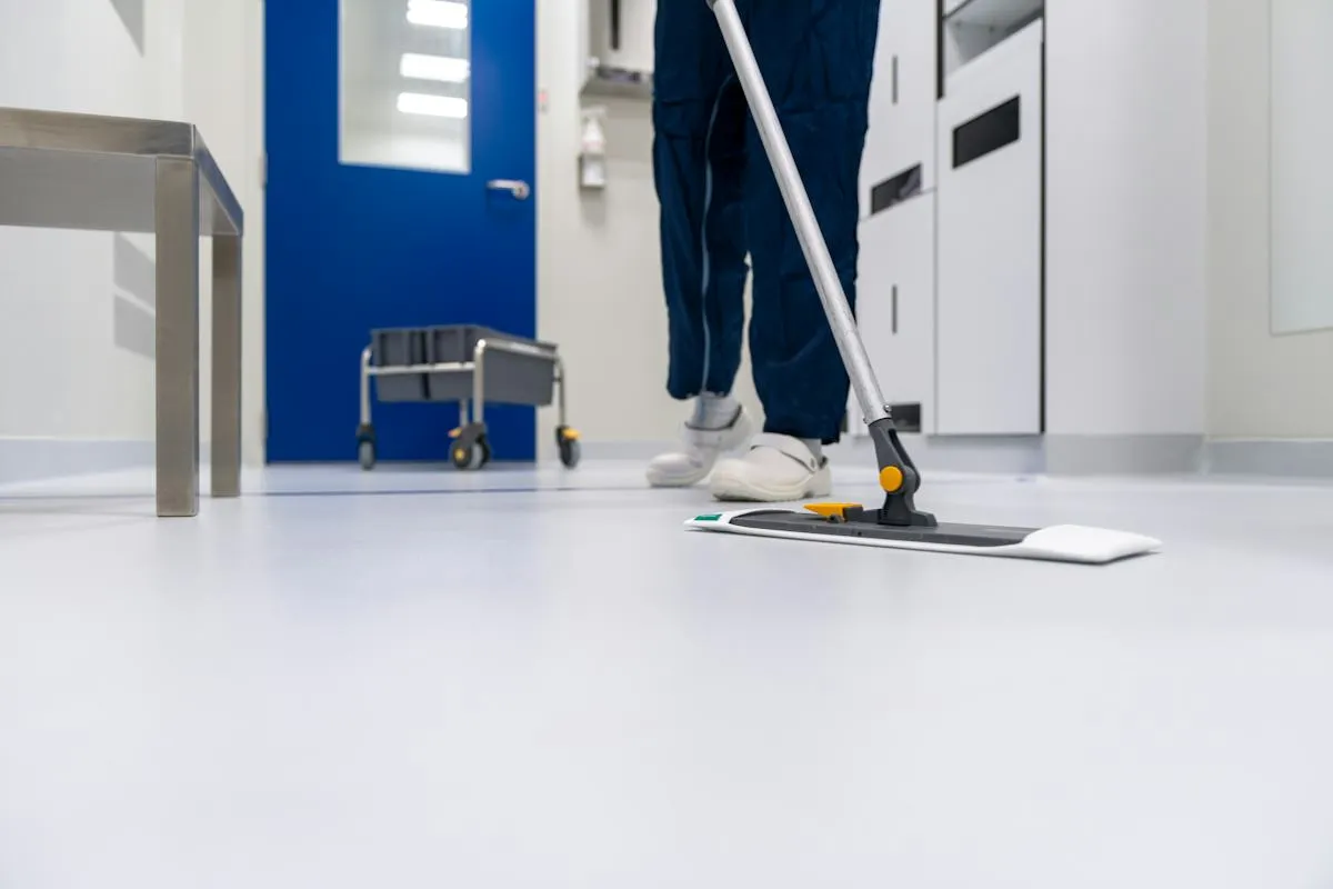 Professional cleaner mopping a light-coloured floor